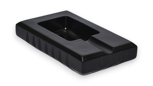 Black rectangular object with a textured surface on a white background