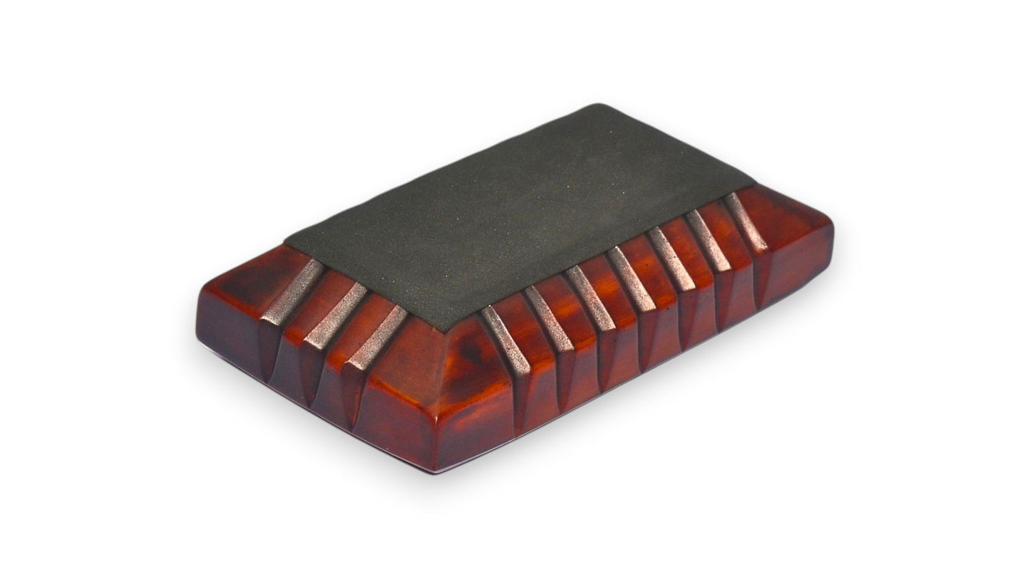 Rectangular ashtray with black top and red bottom on a white background