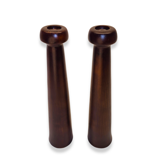 Two wooden pepper mills on a white background