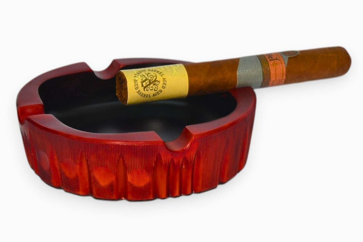 Red ashtray with a cigar inside on a white background