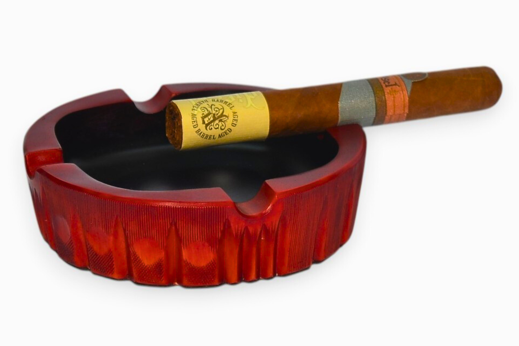 Red ashtray with a cigar inside on a white background
