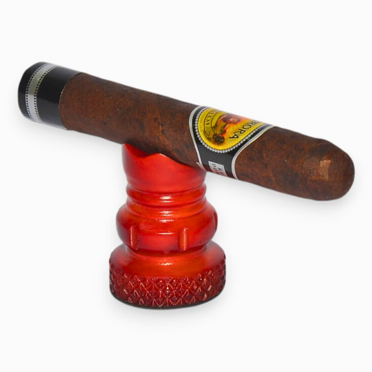 Cigar on a red metal stand with a white background
