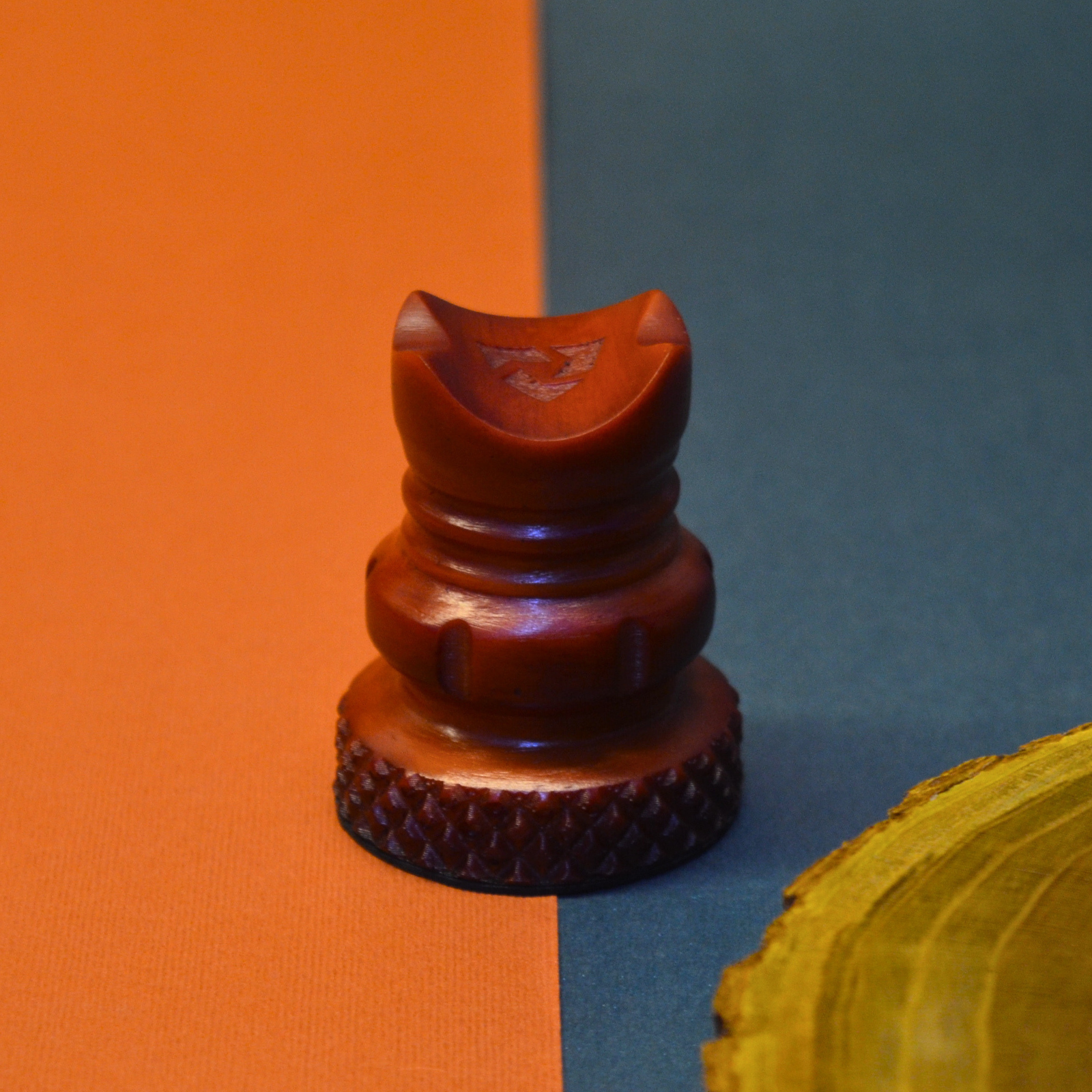 Wooden chess piece on an orange and blue background