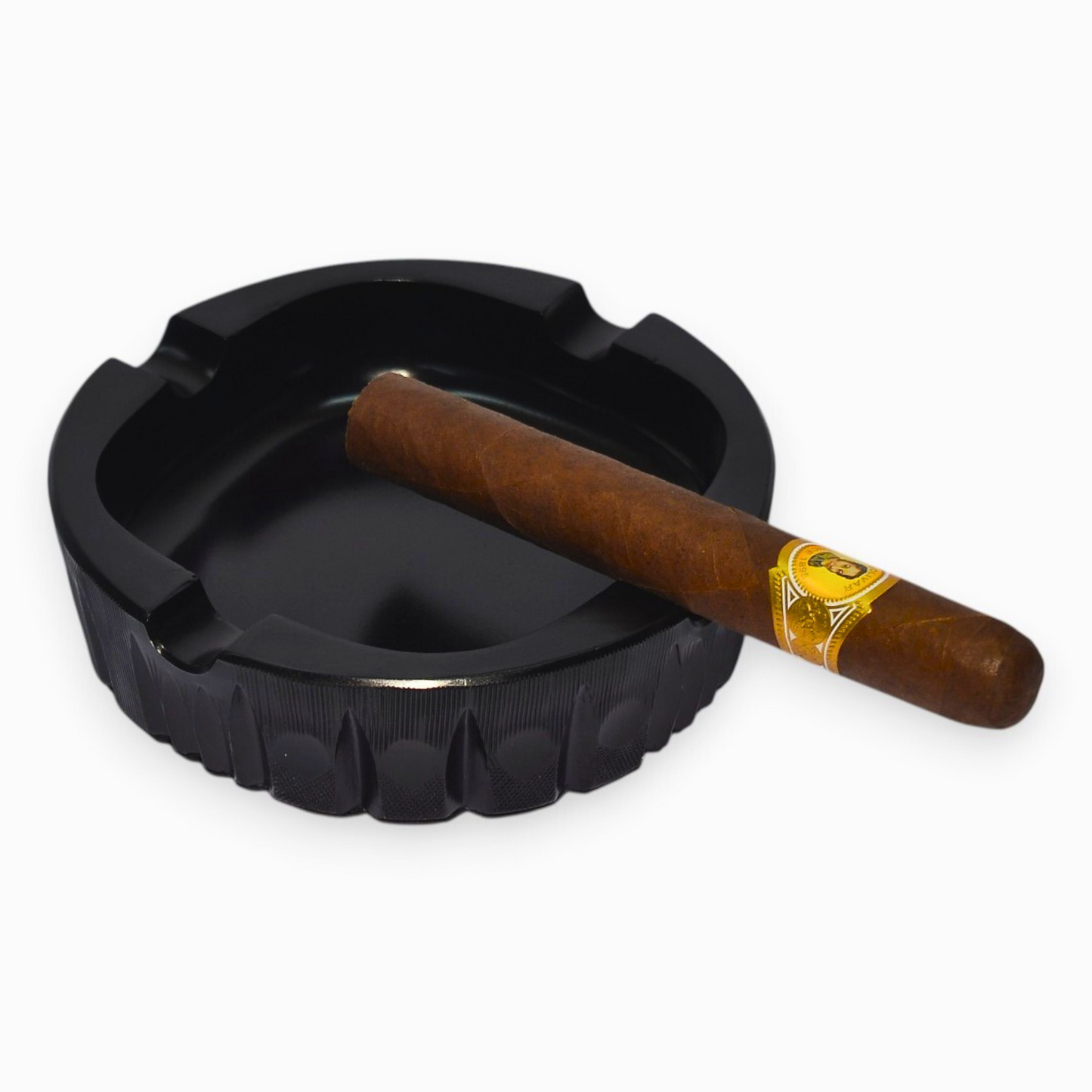 Black ashtray with a cigar on a white background