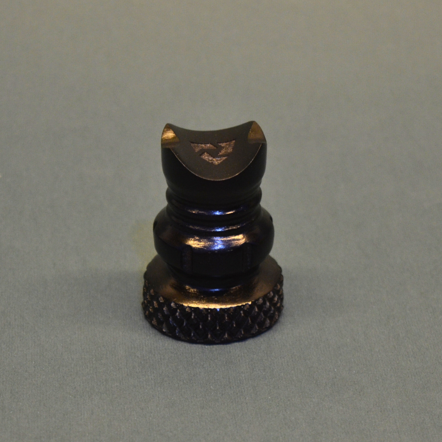 Black and gold object on a gray background