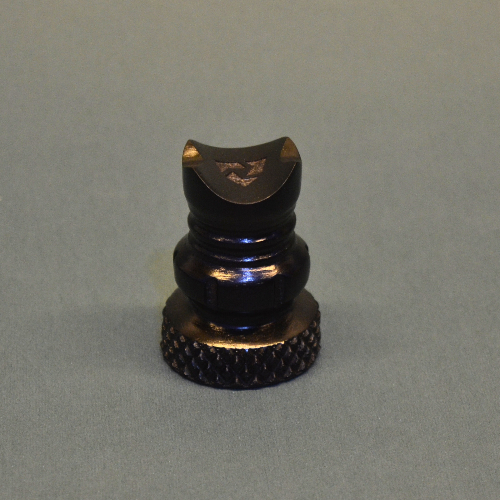 Black and gold object on a gray background