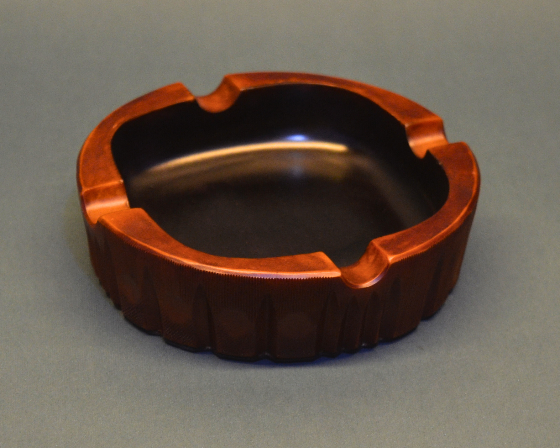 Wooden ashtray on a gray background