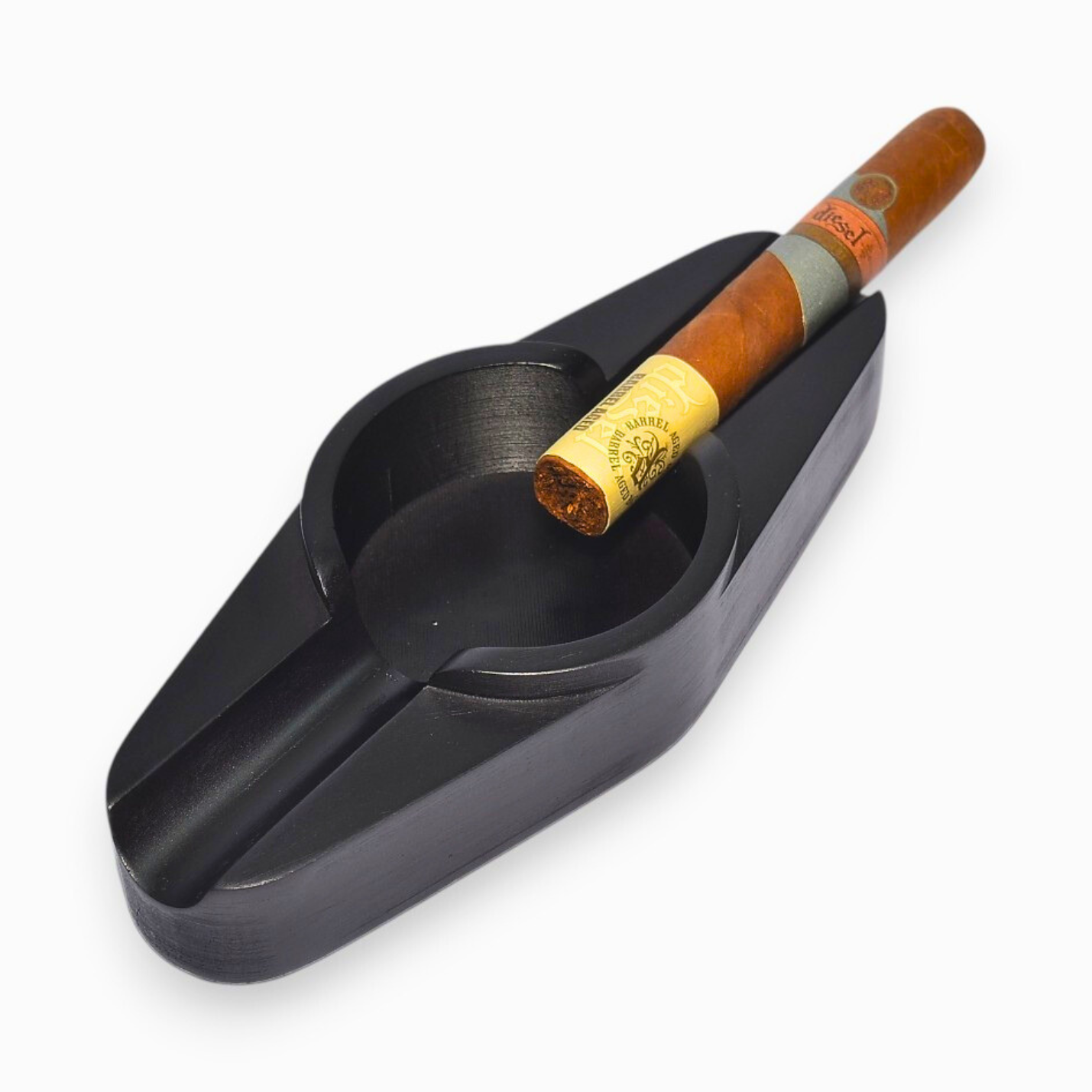 Black cigar ashtray with a cigar on a white background