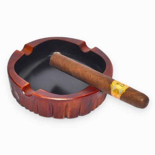 Wooden ashtray with a cigar on a white background