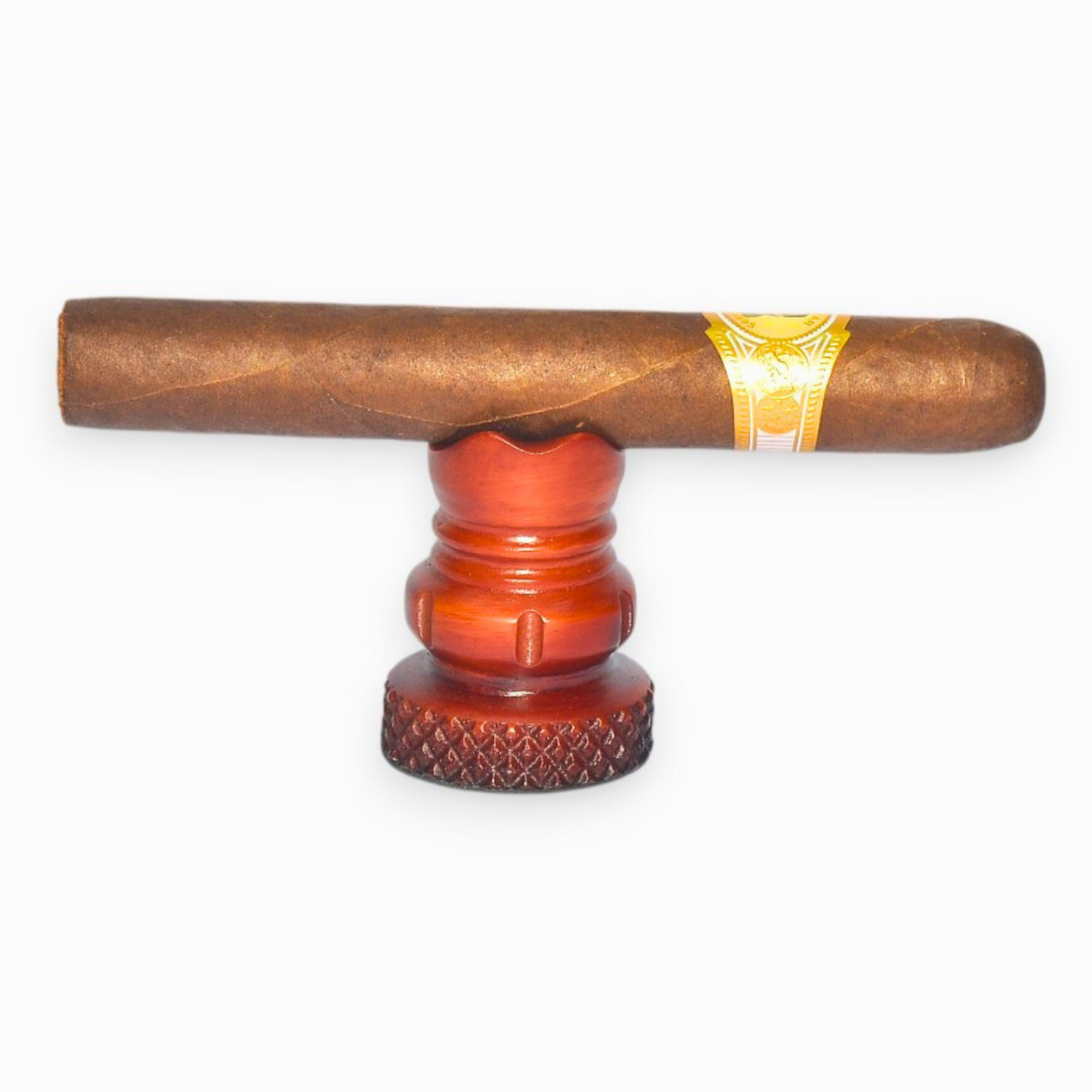 Cigar on a red and brown humidor against a white background