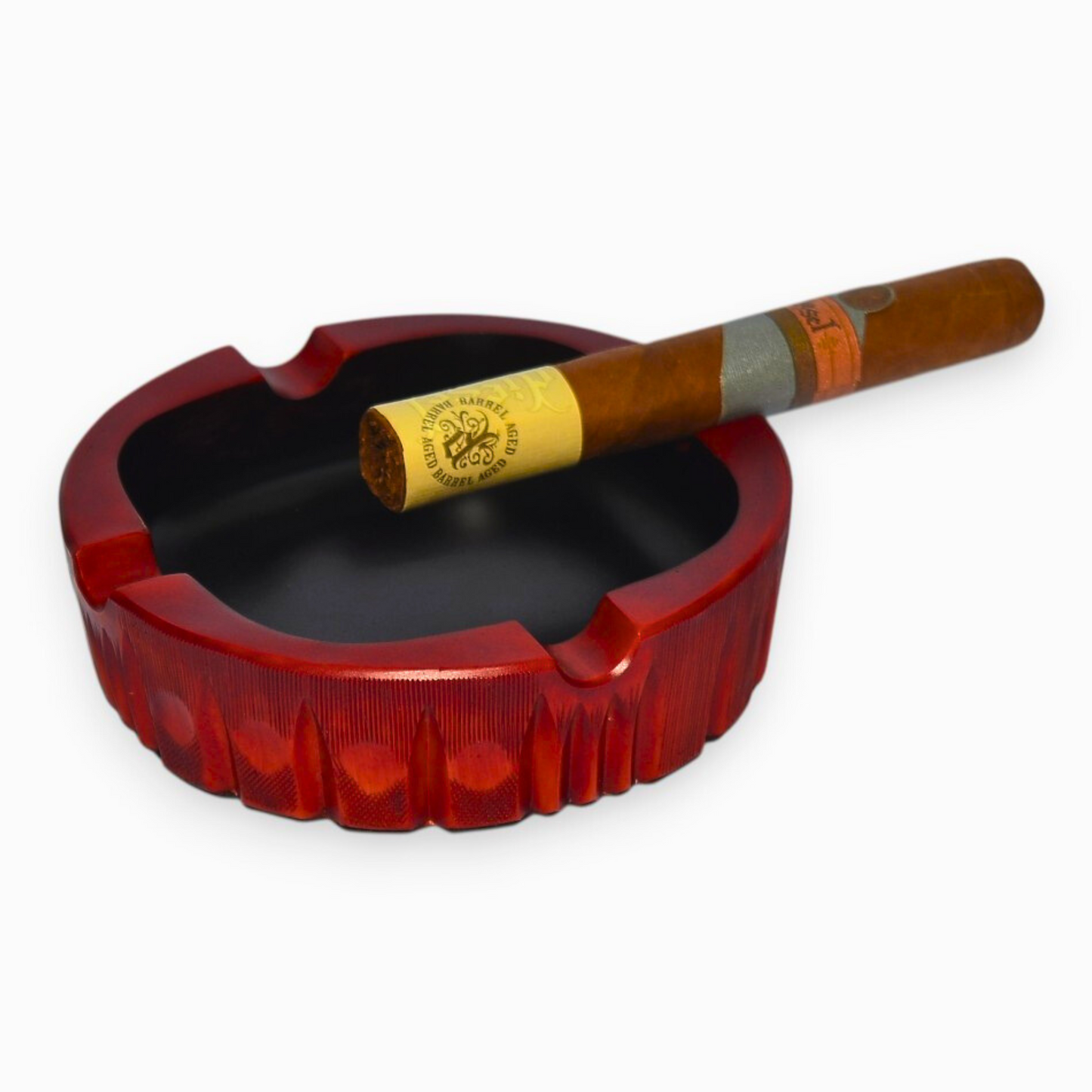 Red ashtray with a cigar on a white background
