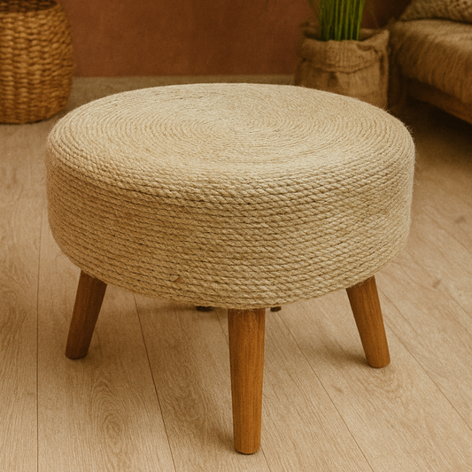 Round woven stool with wooden legs on a wooden floor