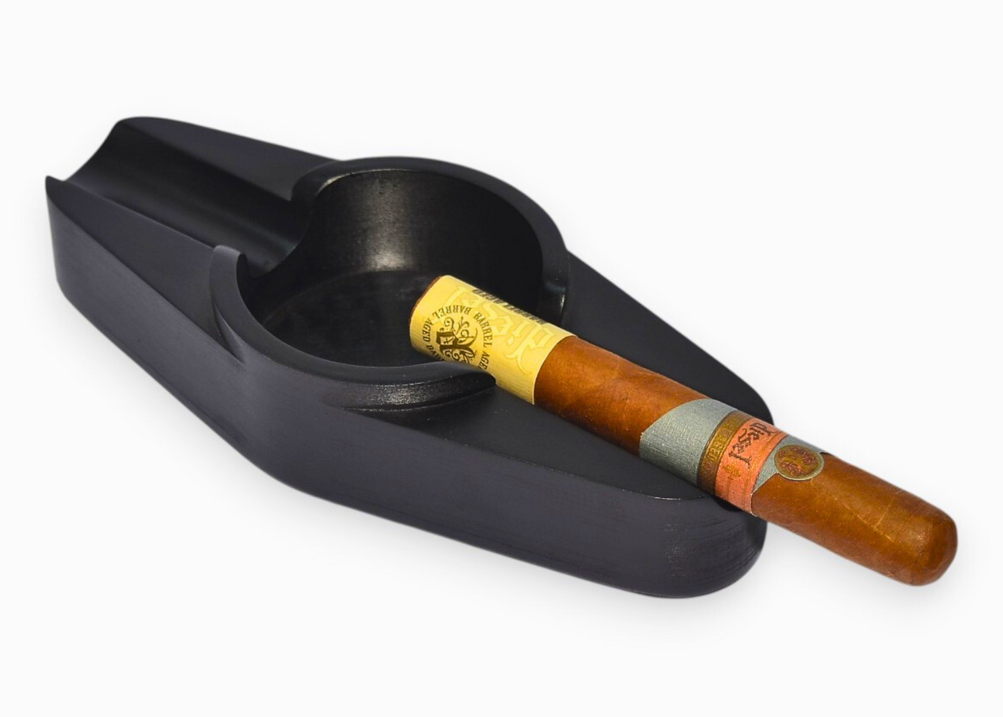 Black cigar ashtray with a cigar inside on a white background