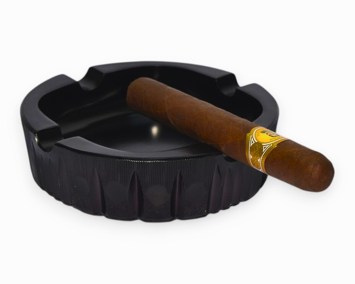 Black ashtray with a wooden-handled cigar on a white background