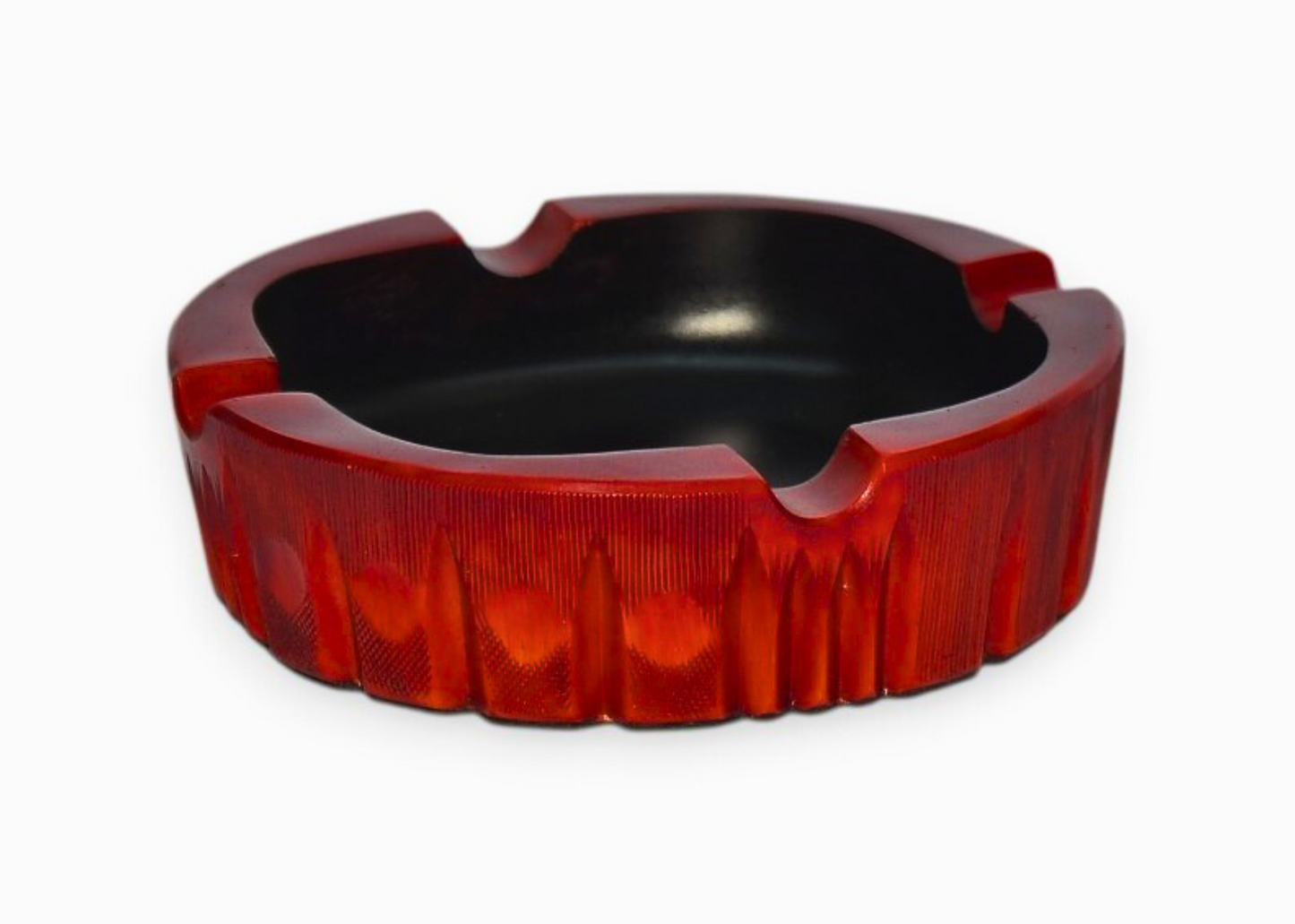Red and black ashtray on a white background