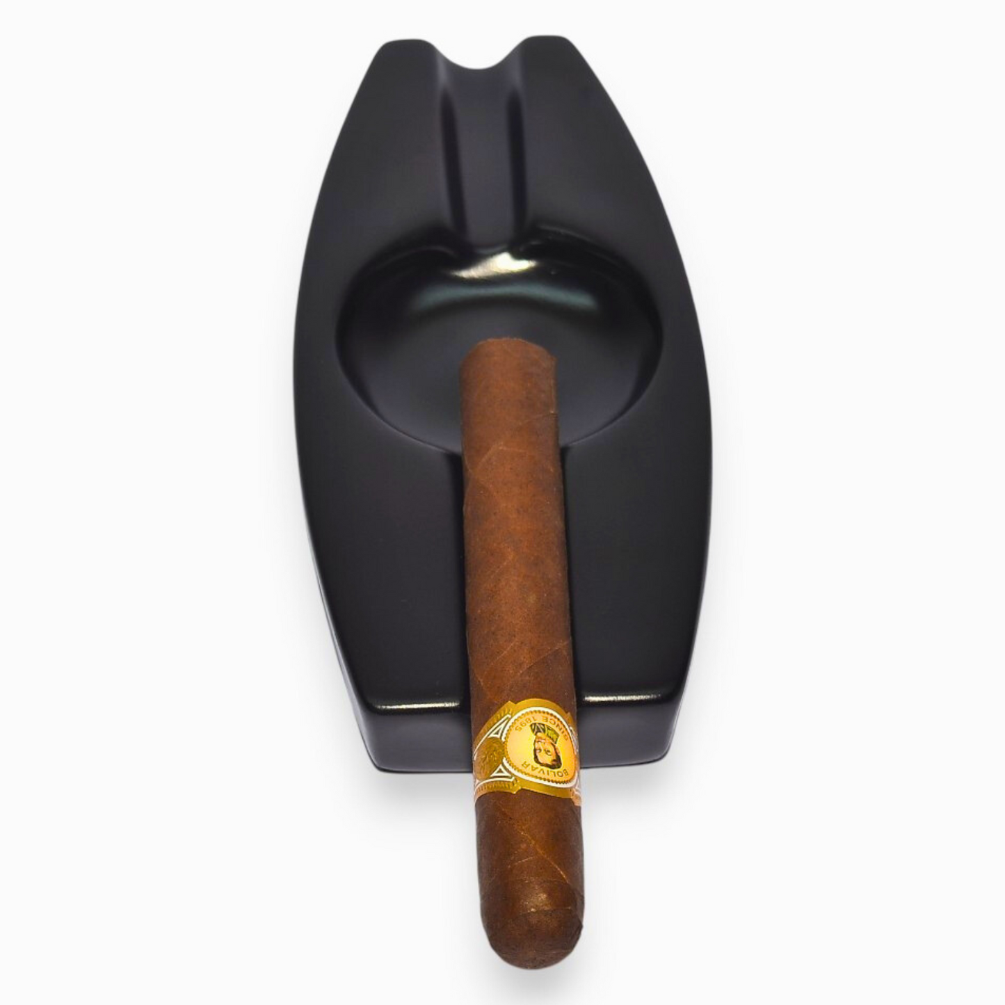 Black cigar ashtray with a wooden cigar on a white background