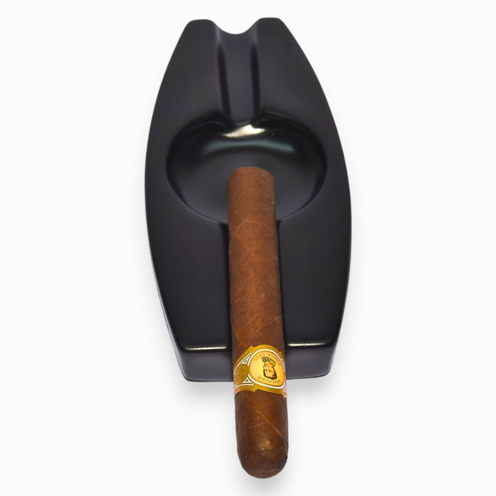 Black cigar ashtray with a wooden cigar on a white background