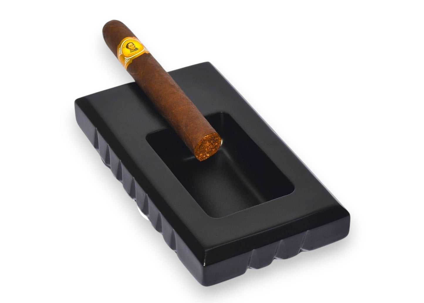 Cigar in a black ashtray on a white background