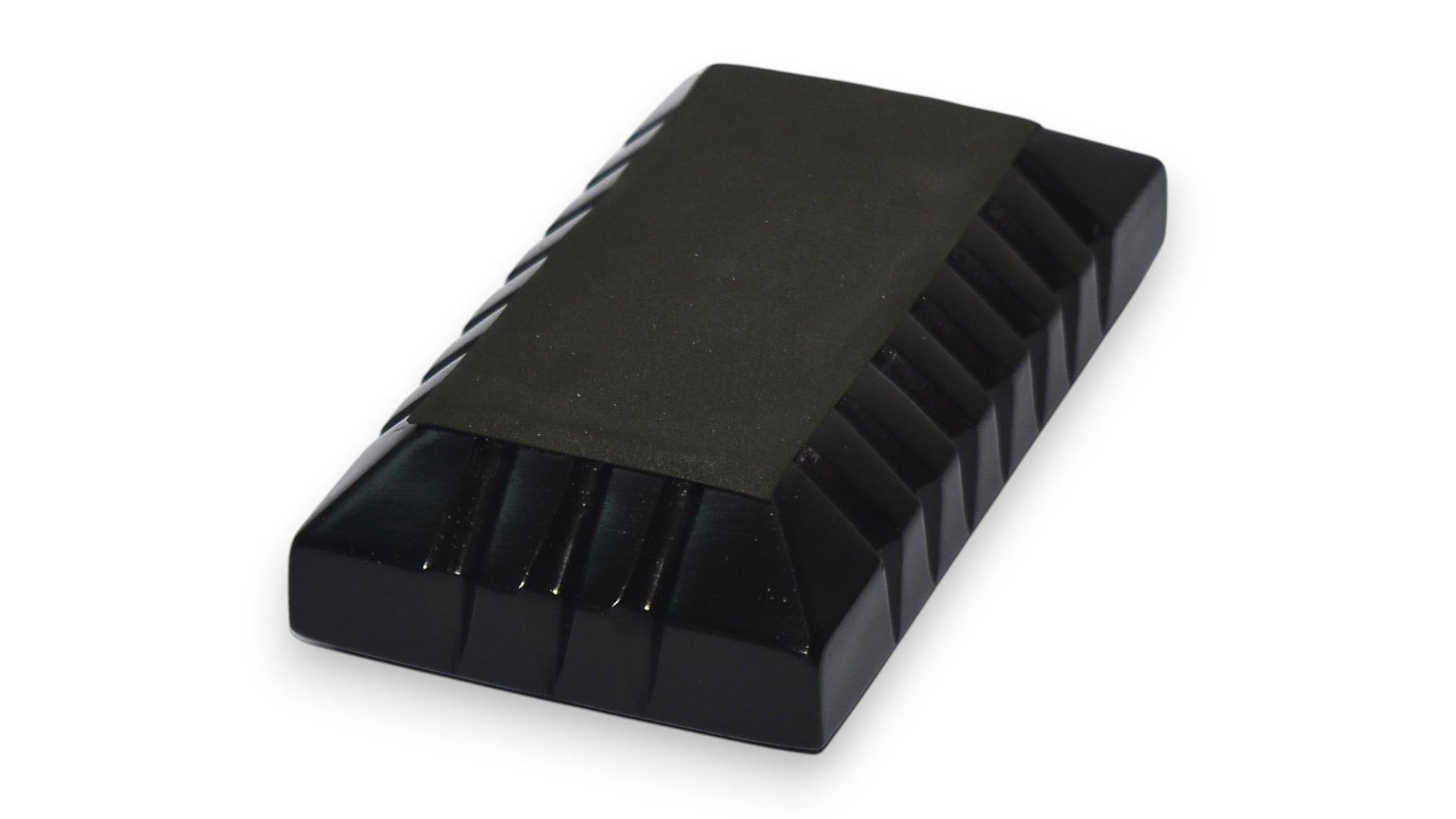 Black rubber block with grooves on a white background