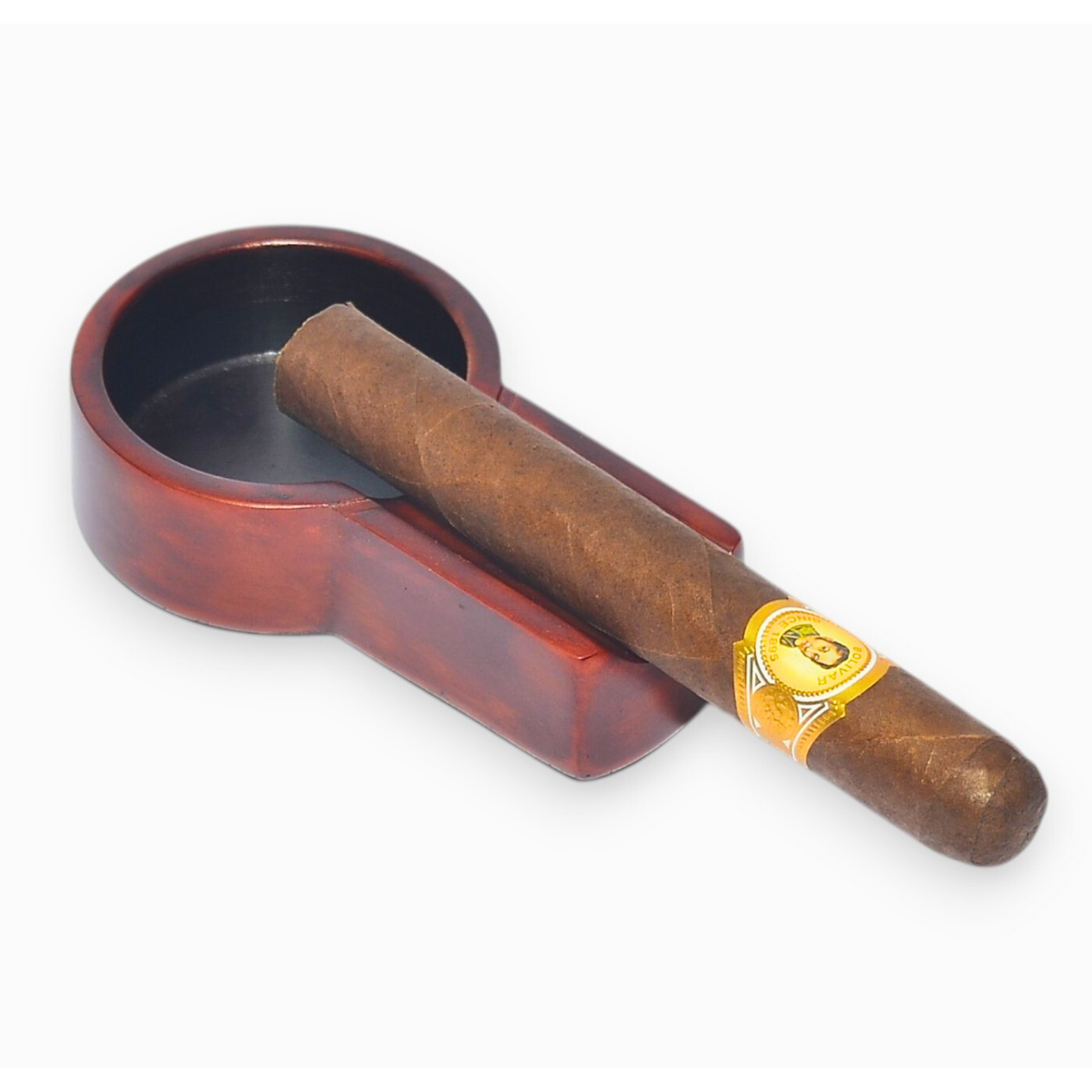 Cigar with a band in a red ashtray on a white background