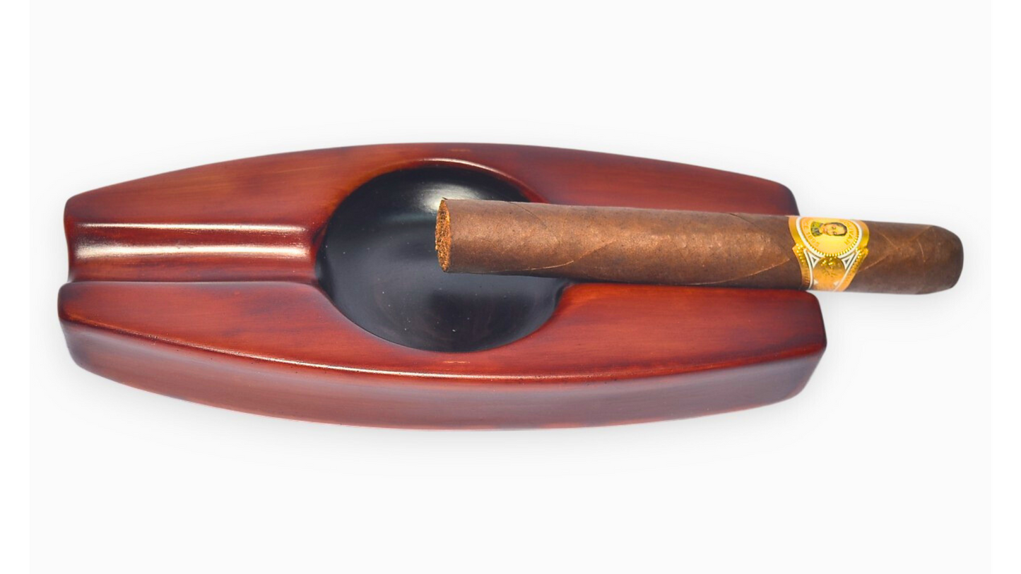 Wooden cigar ashtray with a single cigar on a white background