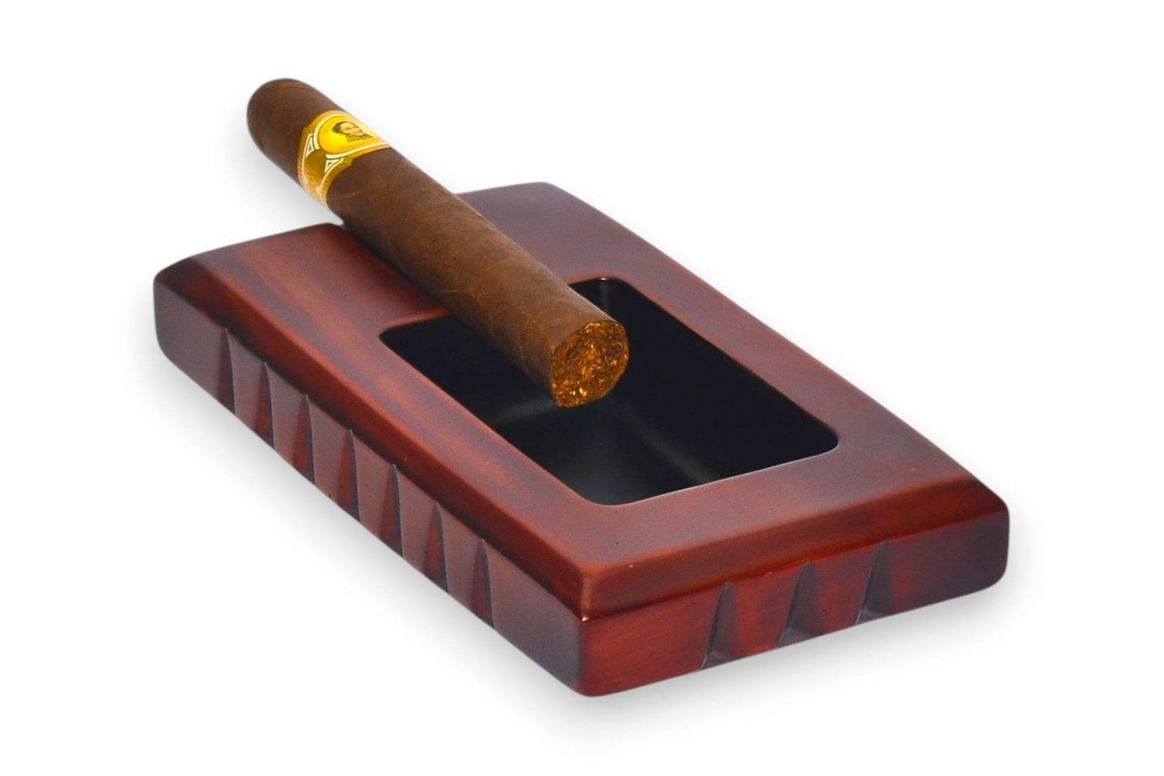Cigar in a wooden ashtray on a white background