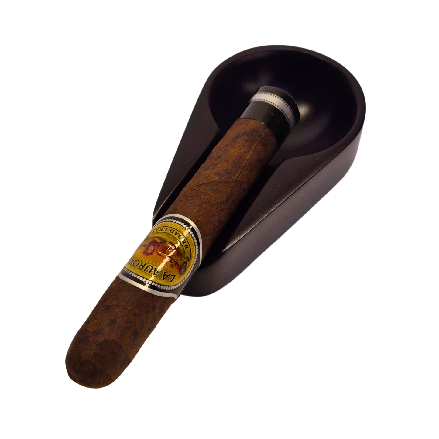 Cigar with La Aroma label in a dark brown humidor on a white background