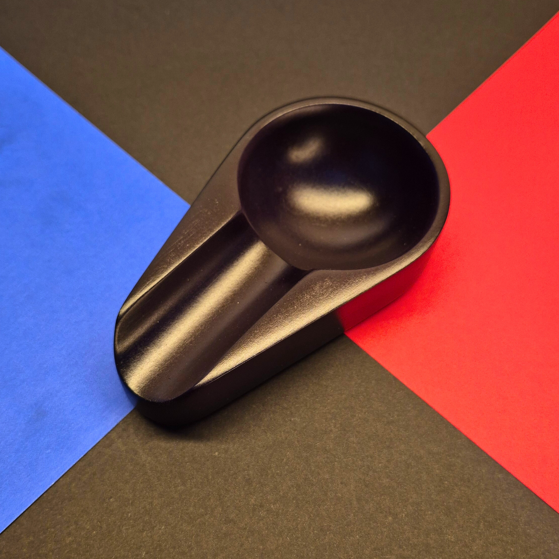Black spoon rest on a multicolored background