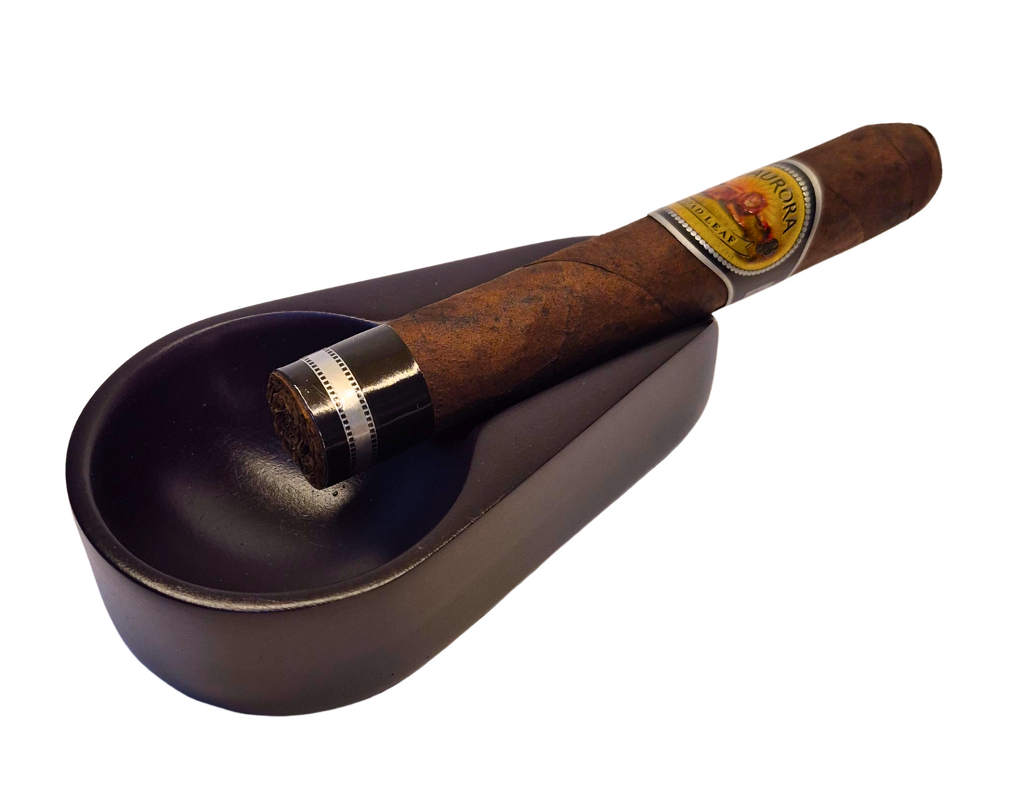 Cigar on a dark ashtray with a white background