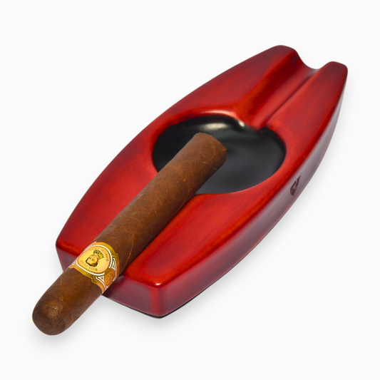 Red cigar ashtray with a cigar on a white background