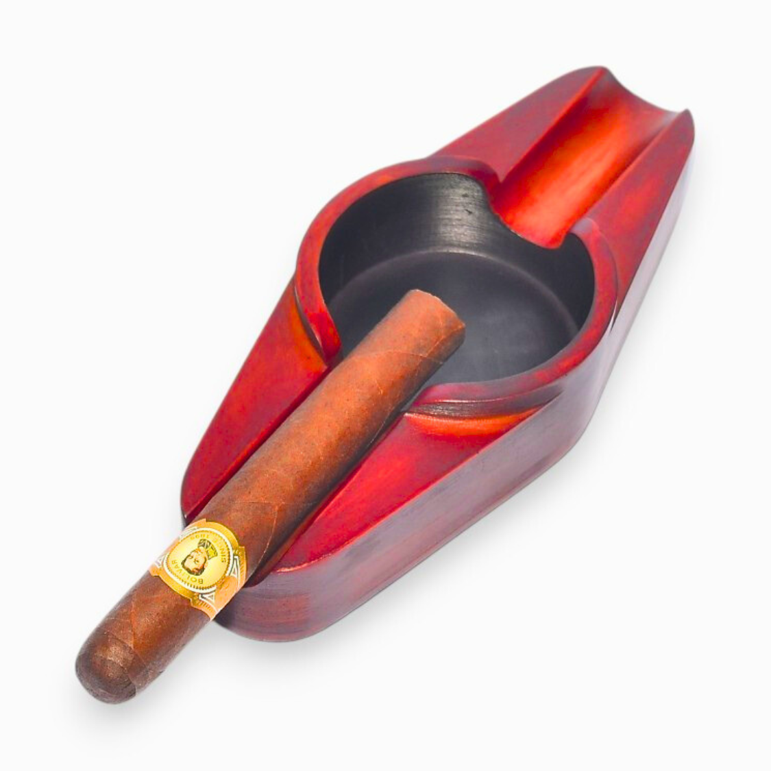 Red and black ashtray with a cigar on a white background