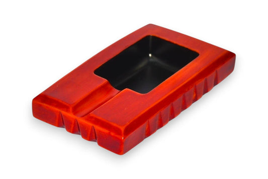 Red rectangular ashtray with a black interior on a white background