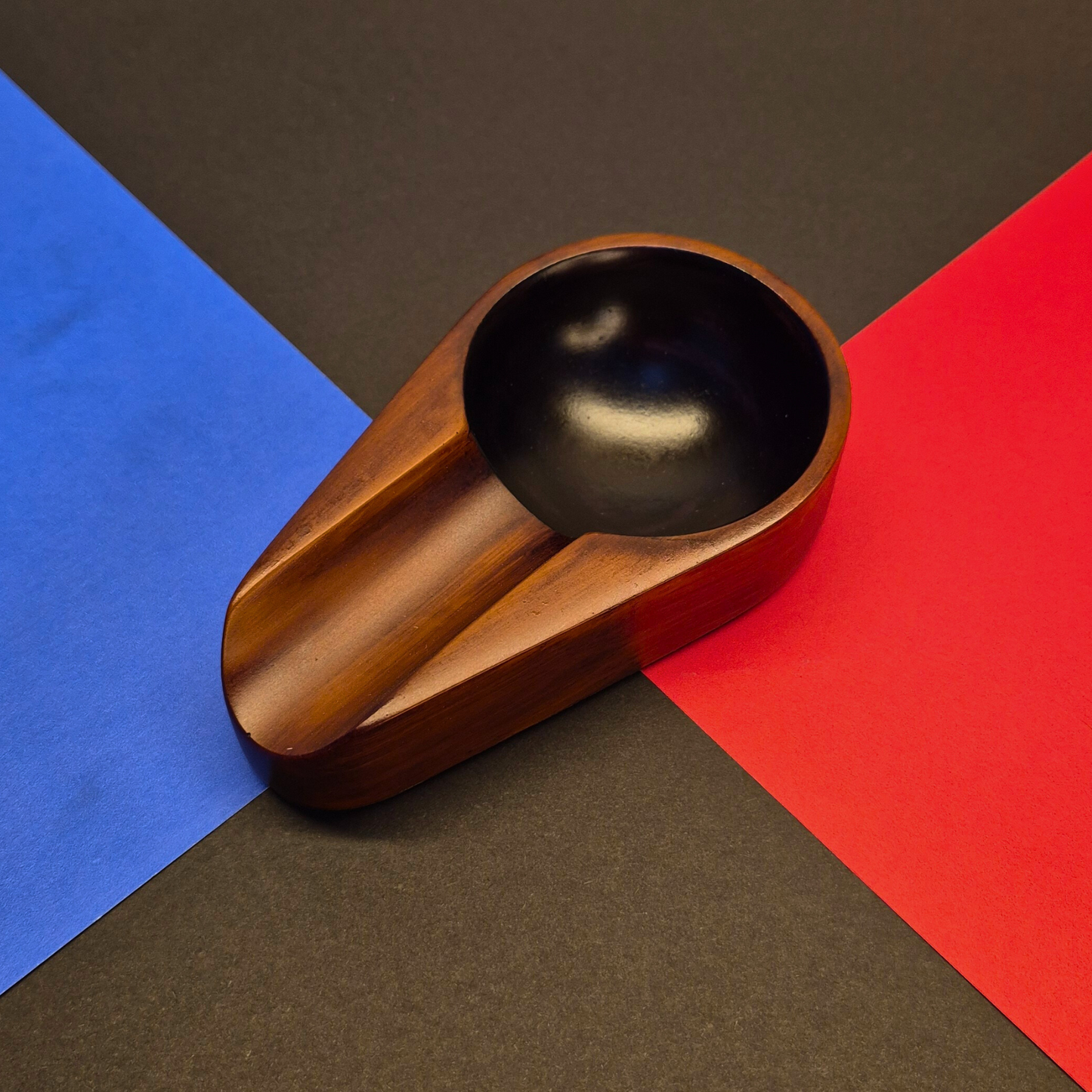 Wooden spoon rest on a colorful geometric background