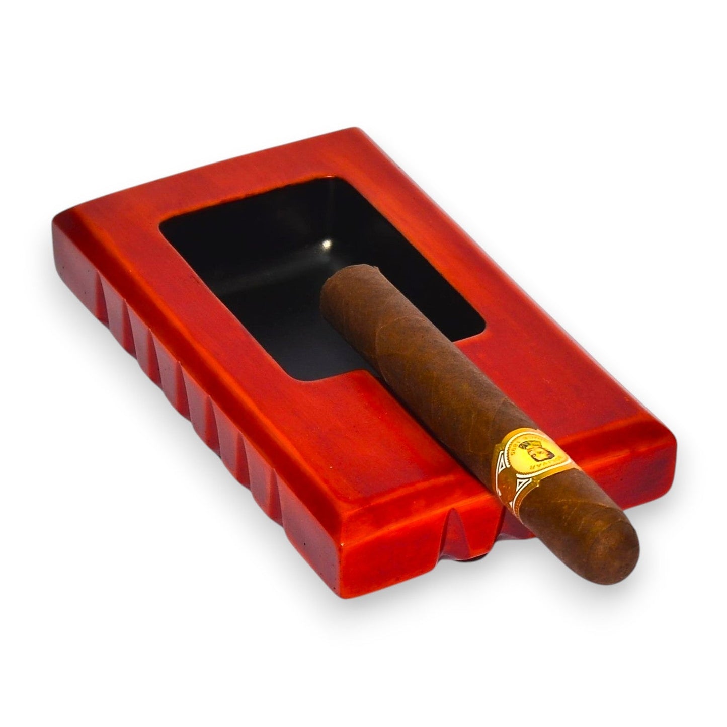 Red ashtray with a single cigar on a white background