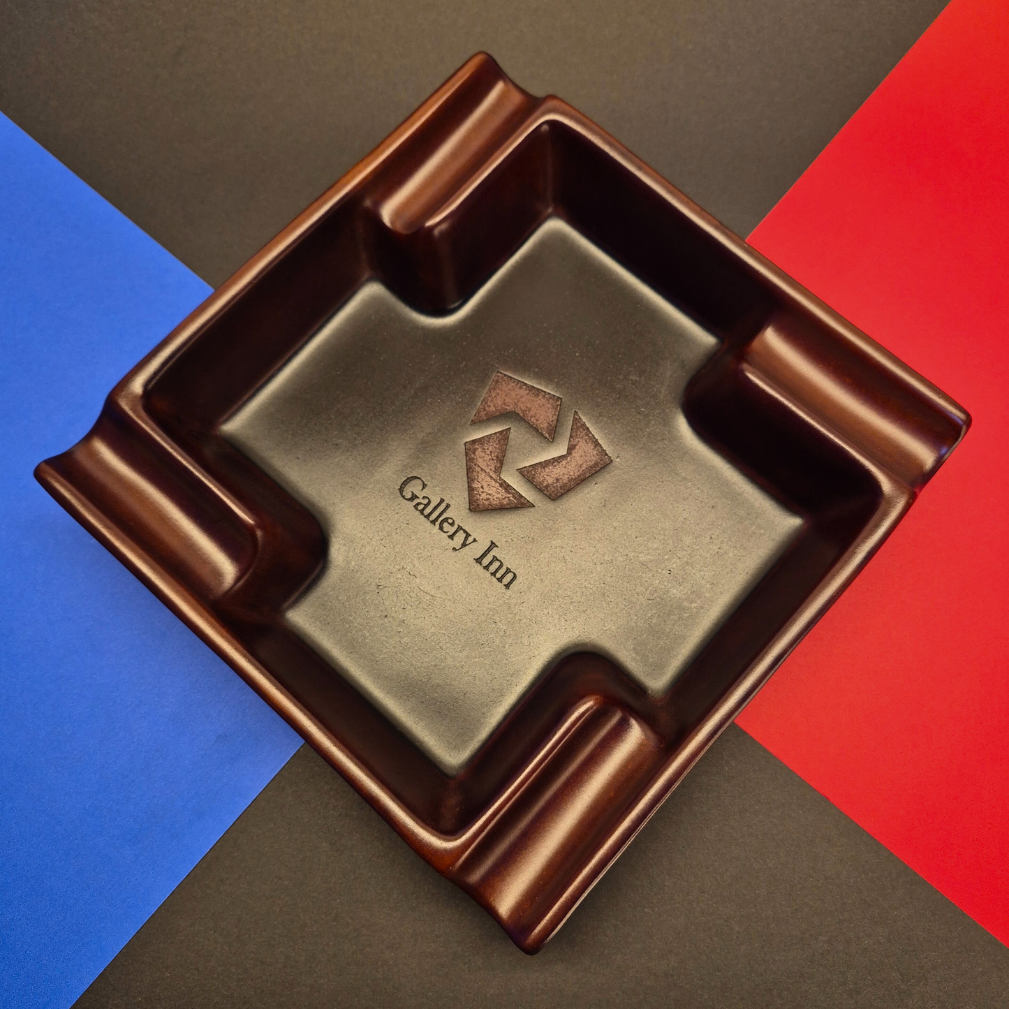 Brown square ashtray with 'Gallery Inn' logo on a multicolored background