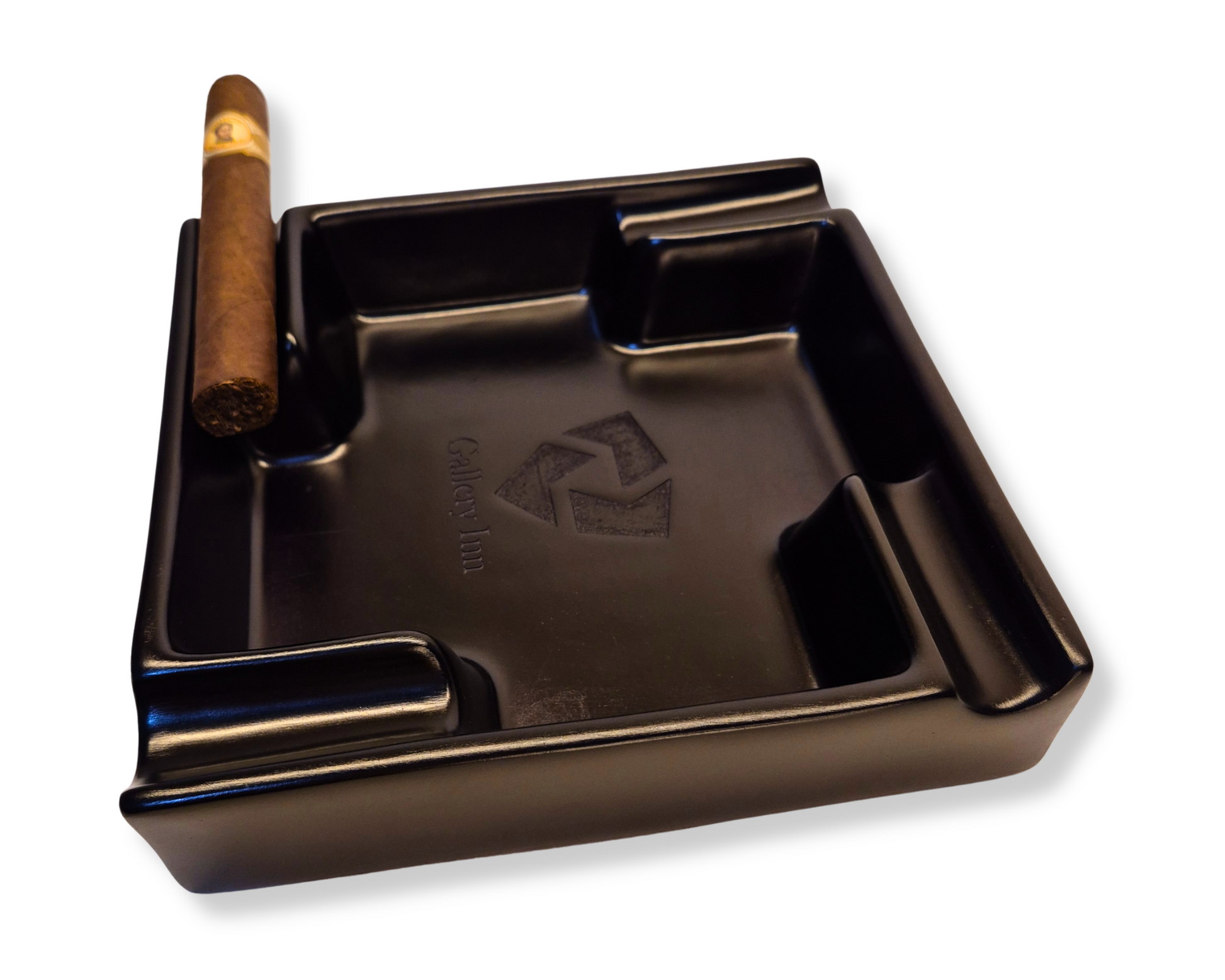 Black ashtray with a cigar on a white background
