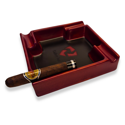 Red ashtray with a cigar on a white background
