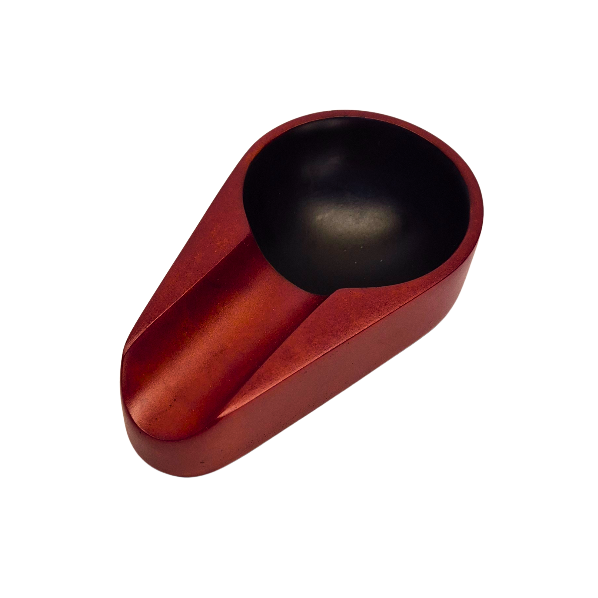 Red and black ceramic scoop on a white background