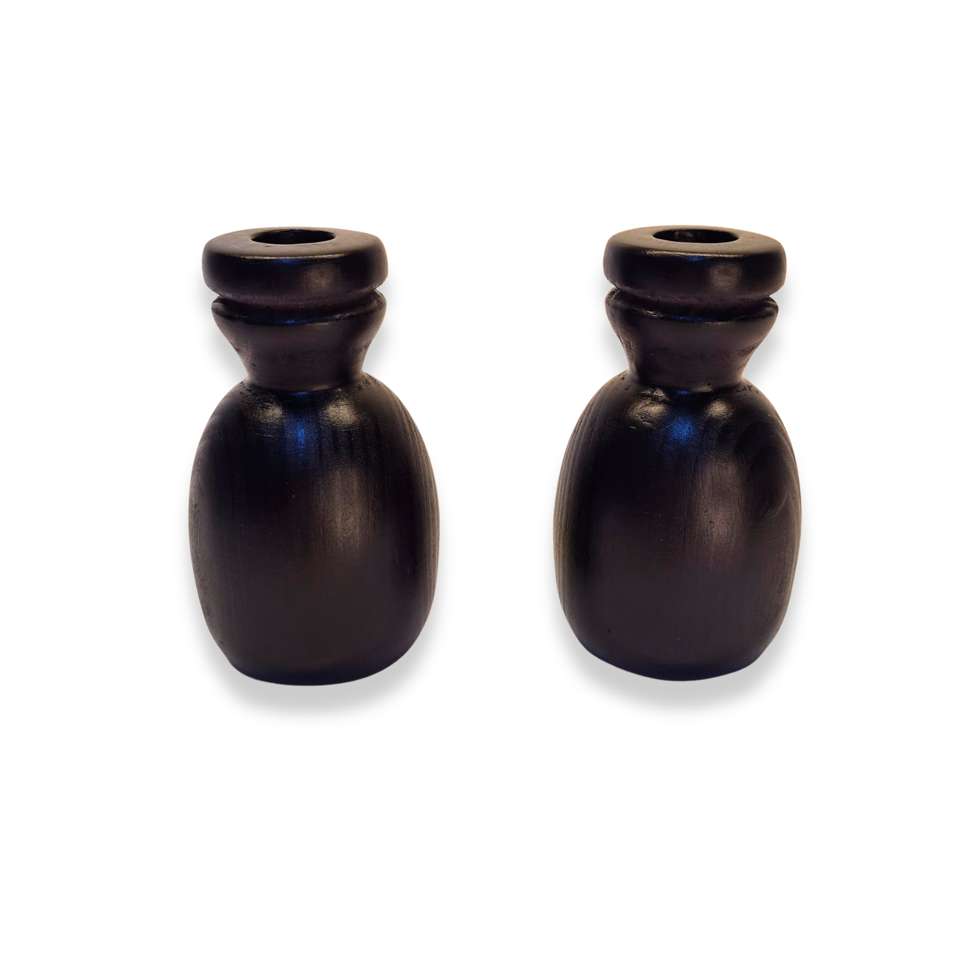 Two black ceramic candle holders on a white background