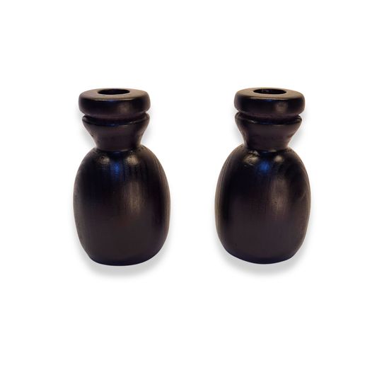 Two black ceramic candle holders on a white background