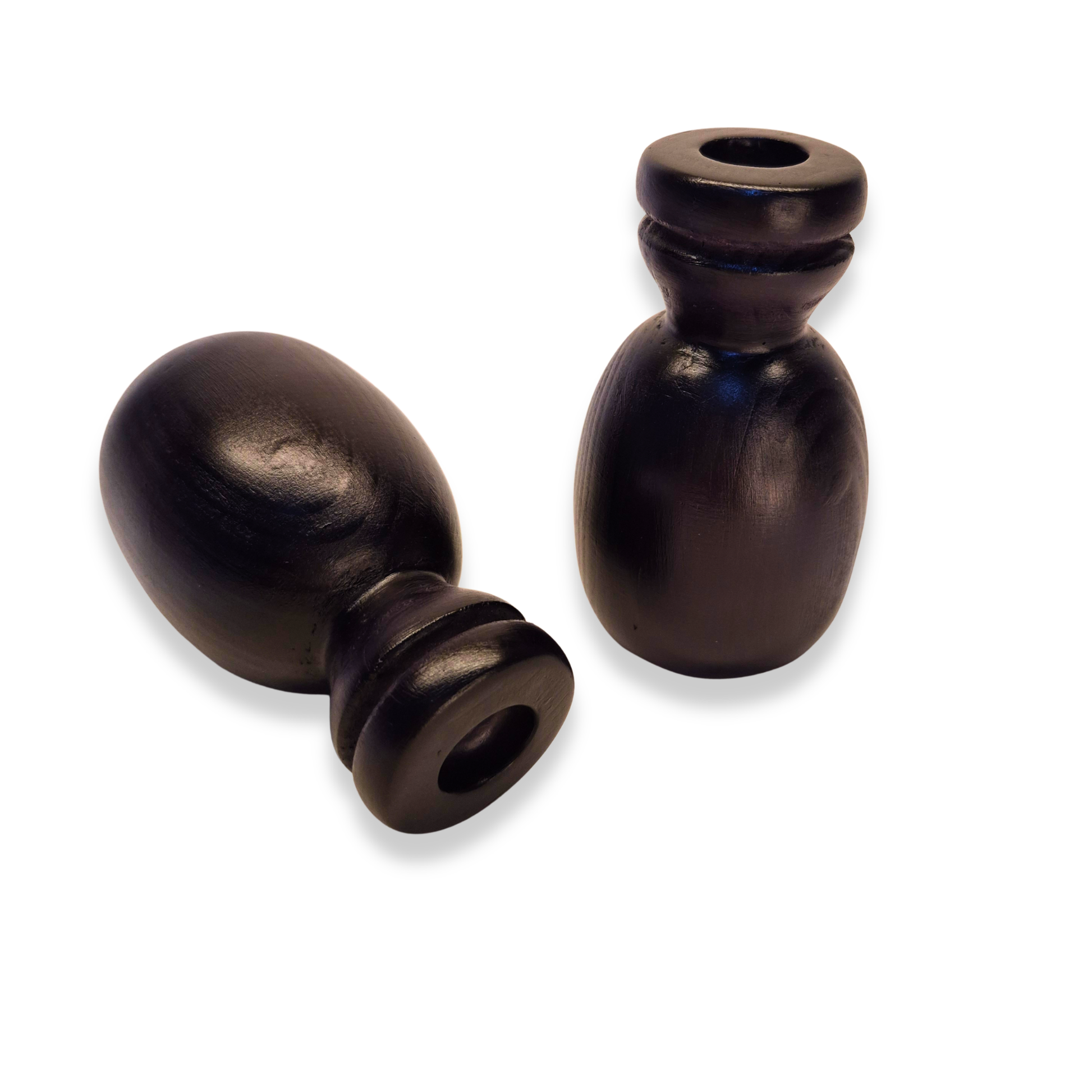 Two black curtain rods finials on a white background