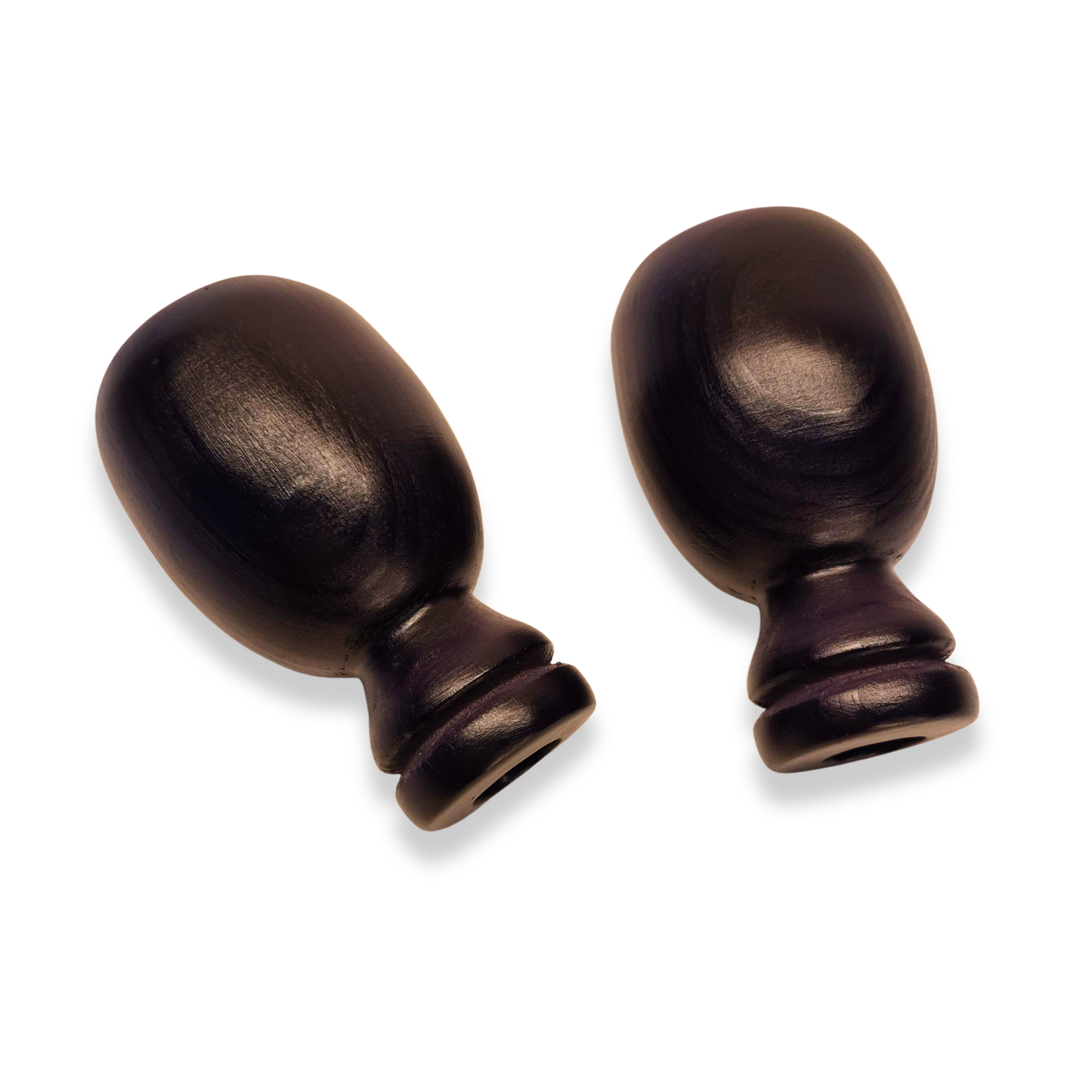 Two bronze curtain finials on a white background