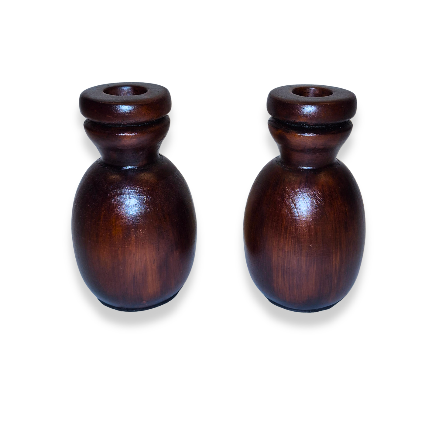 Two wooden candle holders on a white background