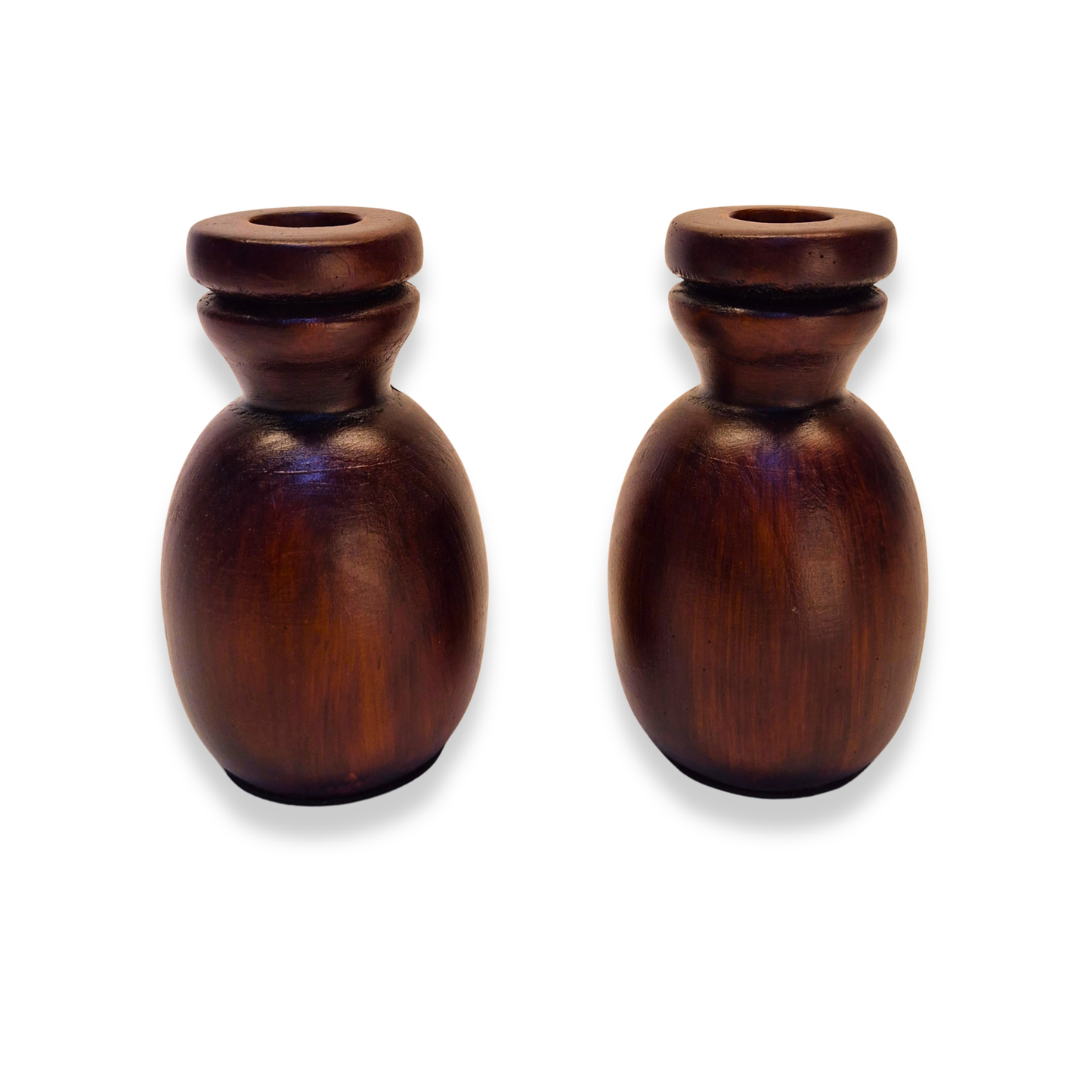 Two wooden candle holders on a white background