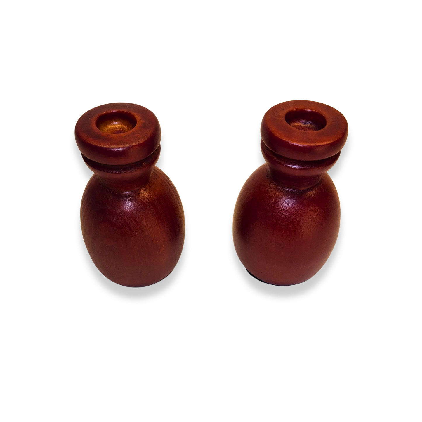 Two wooden candle holders on a white background