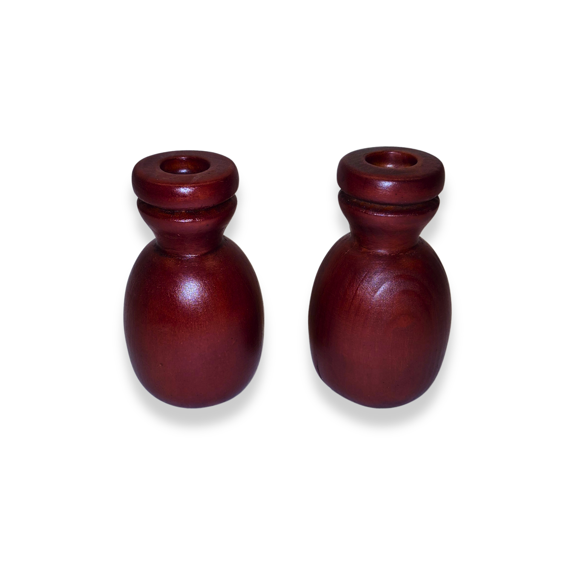 Two wooden candle holders on a white background