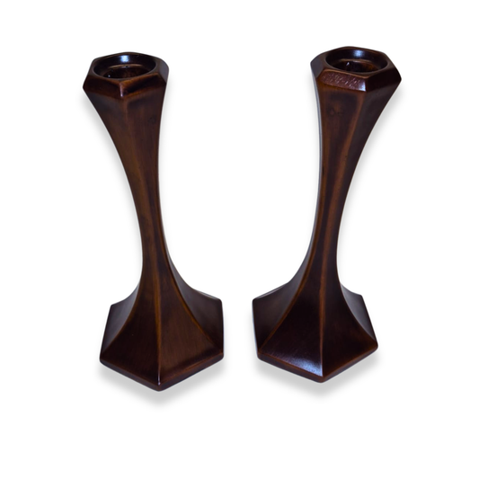 Pair of dark brown candle holders on a white background