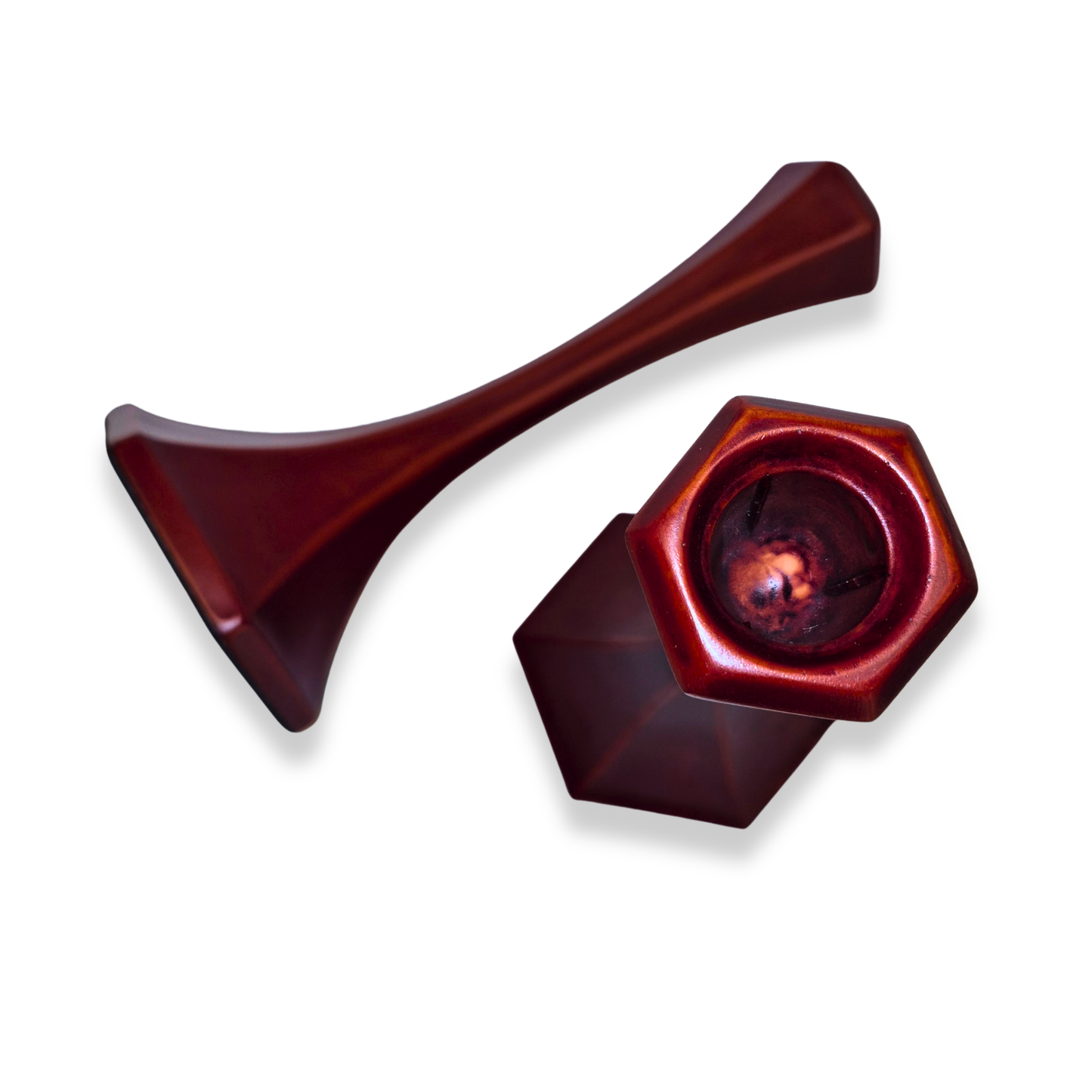 Two red metal objects on a white background