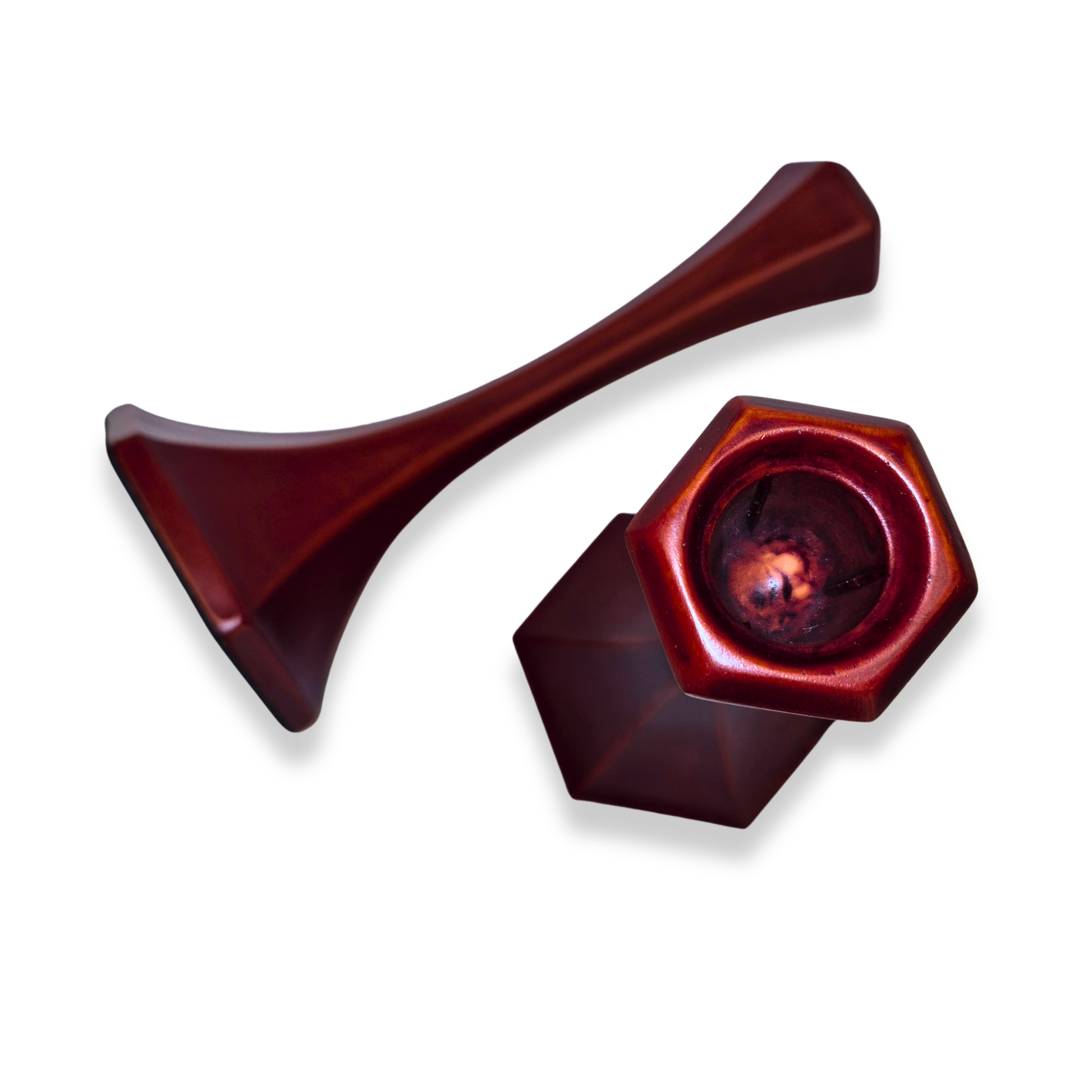 Two red metal objects on a white background