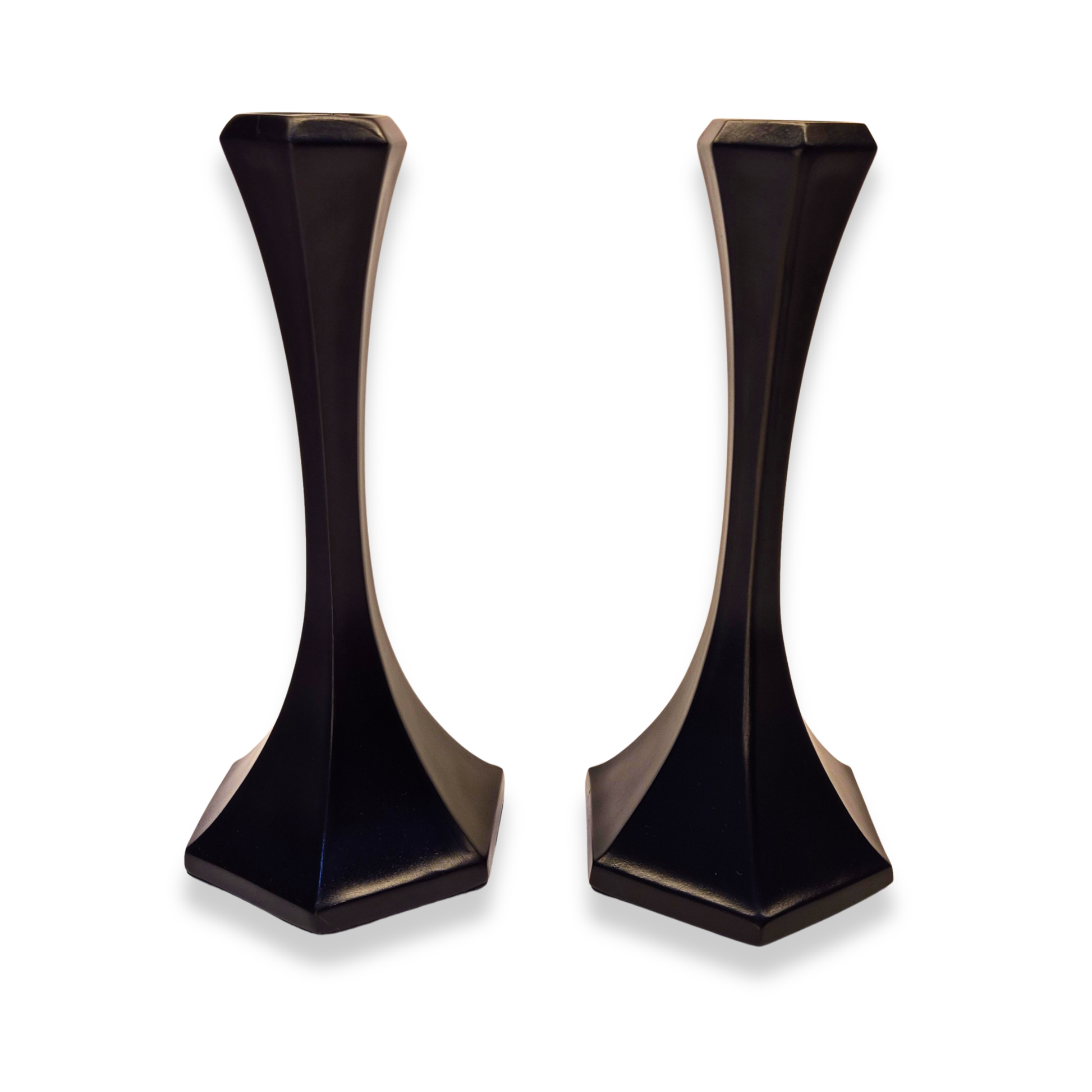 Pair of black and gold geometric candle holders on a white background
